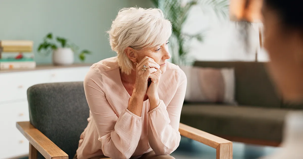 Woman sitting and thinking with therapist - when you should consider therapy